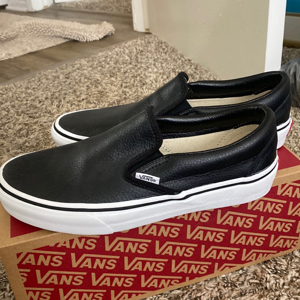 Black leather slip on vans. Never worn